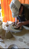 Artisan shapes clay on a pottery wheel, the manual process to handmade the palo santo incienso holder for Andina World. Handmade In Peru