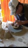 Aetisan crafting the incienso palo santo holder. Process to made a incienso palo santo holder by shaping a clay pot on a pottery wheel in a Peruvian workshop for Andina World