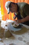 Process to creata a handmade incienso palo santo holder for Andina World. The artisan uses a pottery wheel  shaping the clay. Handmade in Peru for Andina World