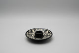 A round ceramic Palo Santo holder, decorated with white geometric tribal patterns. Handmade in Peru. Andina World